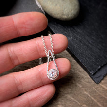 Load image into Gallery viewer, a 6mm white topaz set in a bezel and set into the bottom of a teardrop shaped textured pendant
